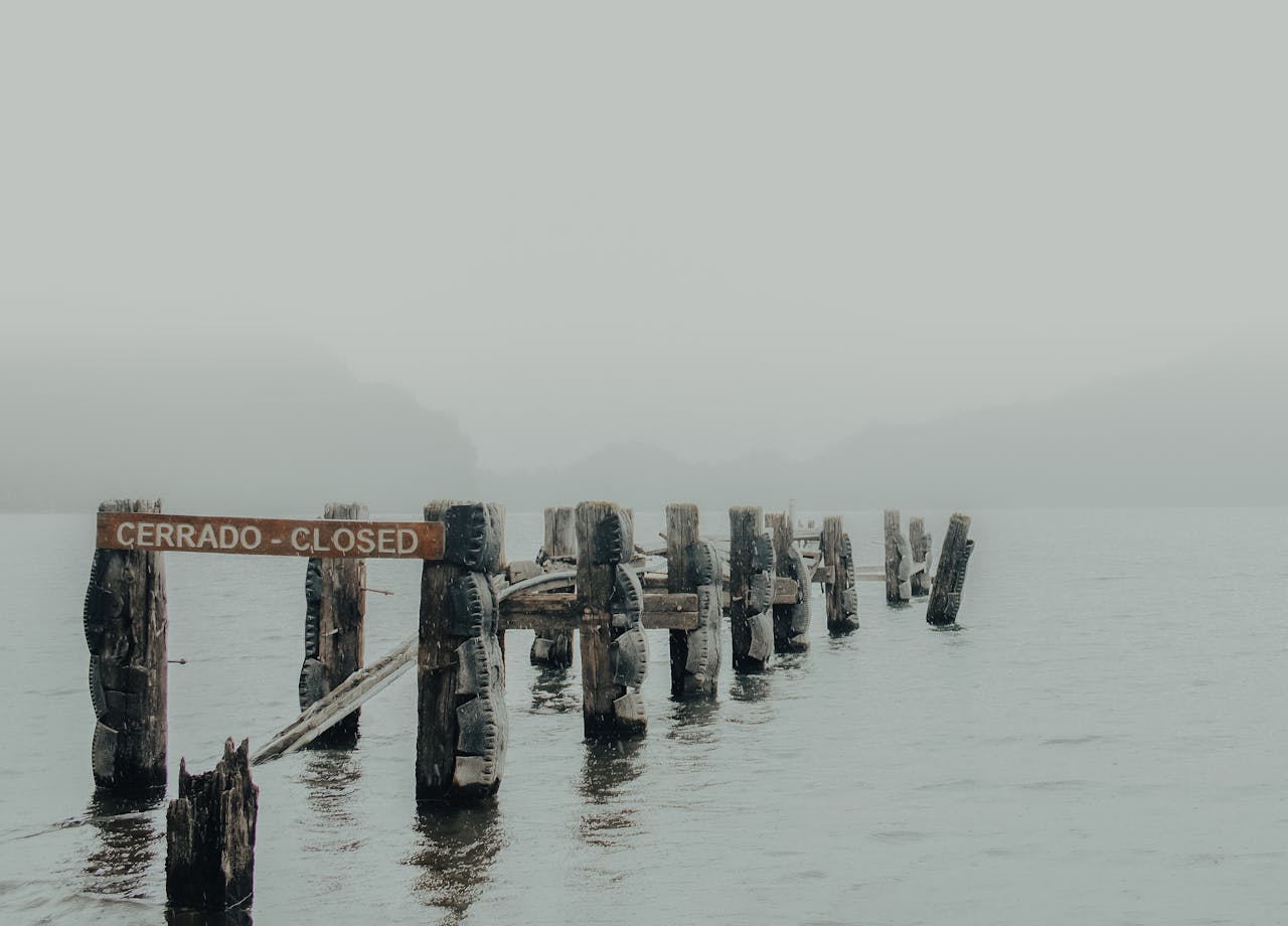 Broken Dock on a Foggy Body of Water